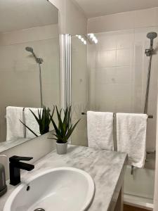 a white bathroom with a sink and a mirror at Brisa Marina, Altea in Alicante