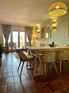 a dining room with a wooden table and chairs at Brisa Marina, Altea in Alicante