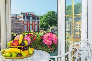 a plate of fruit on a table on a balcony at Hotel Ipek Palas in Istanbul