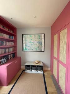 a room with pink walls and a window and a door at Beautiful Family-Friendly 4BD House - North Sheen in Kew Gardens