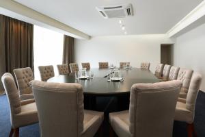 a conference room with a table and chairs at Dunav Plaza Hotel in Ruse