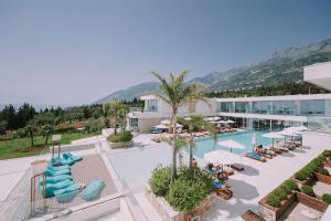 a hotel with a pool and a resort at Empire Beach Resort ADULTS ONLY in Dhërmi
