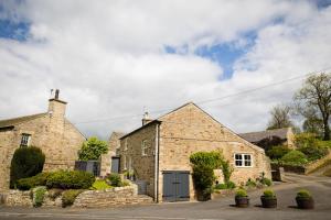 an old stone house with a garage at Low Thearns in Barnard Castle