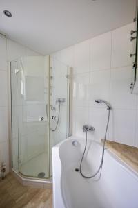 a white bathroom with a shower and a tub at Jordis in Vandans