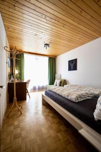 una camera con un grande letto e un soffitto in legno di Jordis a Vandans
