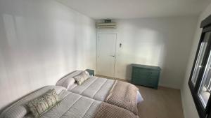 a bedroom with a bed and a green dresser at Txoko Loft Bardenas in Tudela +2 photos