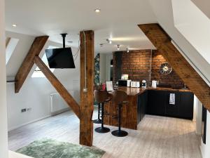 a kitchen with a bar in a loft at Cardiff Arms Bistro & Hotel in Treorky