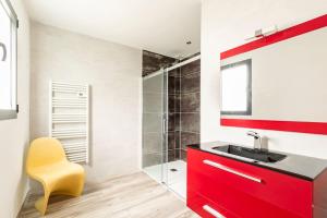 a bathroom with a red cabinet and a sink at Villa des rives du Tarn avec jacuzzi in Montans +38 photos
