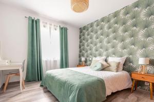 a bedroom with a large bed with a green headboard at Villa des rives du Tarn avec jacuzzi in Montans