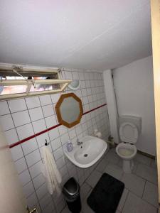 a small bathroom with a sink and a toilet at Demir Pension in Gronau