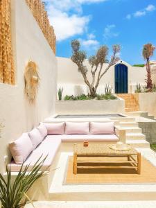a living room with a couch and a table at Villa Bali Cocoon - Piscine - luxe - 4 or 5 Px in Agadir
