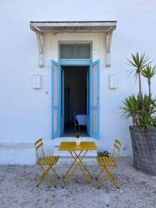 a table and two chairs in front of a building at La Locanda di Felisiano in Monopoli
