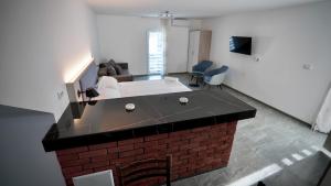 a living room with a brick island in the middle at Apartmani Vila Katarina in Vrnjačka Banja