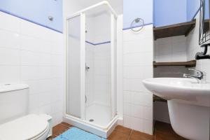 a bathroom with a shower and a toilet and a sink at Casa Paula in Benamahoma +16 photos