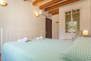 a bedroom with a large bed with two towels on it at Ca's Pobres in Sóller