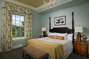 a bedroom with a large bed and a window at The Otesaga Resort Hotel in Cooperstown