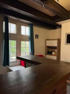 a kitchen with a large wooden table in front of a window at T2 vue sur La Place Plumereau in Tours