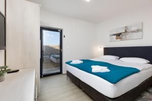 a bedroom with a large bed and a large window at Ferienwohnung mit beheiztem Pool in Villa Gracia in Stara Baška +26 photos