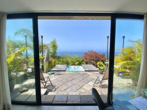 a view from a window of a patio with a swimming pool at Casa Lava Luminosa y con Magníficas Vistas in La Orotava +43 photos