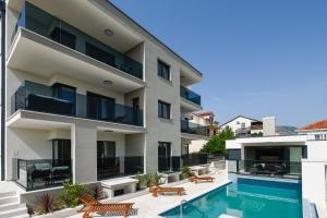 an exterior view of a building with a swimming pool at Luxury Apartments Villa MTG in Orebić