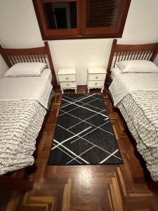 two beds sitting next to each other in a room at Casa Jardim das Colinas in São José dos Campos