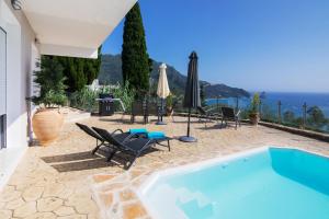 a villa with a swimming pool and a patio at Noir Luxury Suite by CorfuEscapes in Corfu