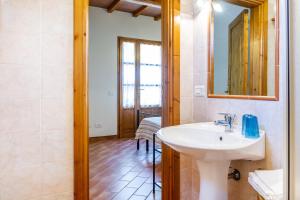 a bathroom with a sink and a mirror at Margherita - Agriturismo La Fattoria in Grosseto