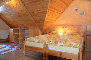a bedroom with a large bed in a attic at Penzion pod Tatrami in Ždiar