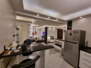 a large kitchen with a stainless steel refrigerator at SAKN 3 - Two Bedroom Apartment in Amman