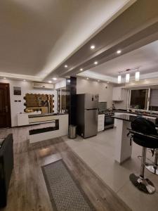 a large kitchen with a refrigerator and a stove at SAKN 3 - Two Bedroom Apartment in Amman