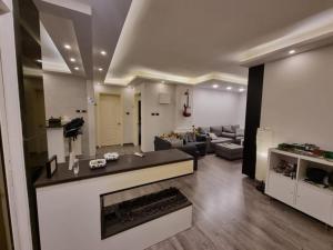 a living room with a couch and a fireplace at SAKN 3 - Two Bedroom Apartment in Amman +7 photos