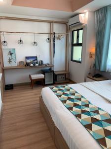 a hotel room with a bed and a checkered floor at Ngoc Khanh hotel in Nha Trang