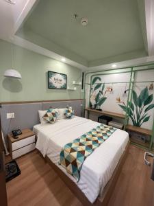 a bedroom with a large white bed with pillows at Ngoc Khanh hotel in Nha Trang