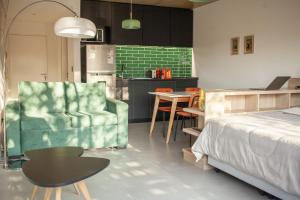 a bedroom with a bed and a table and a chair at Primavera Suites in Buenos Aires