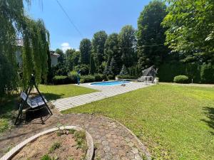 a yard with a bench and a swimming pool at Villa Donata in Sarajevo