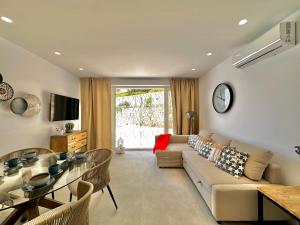 a living room with a couch and a glass table at Loft 18 Beachfront Marbella Center in Marbella