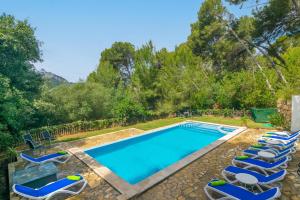 a swimming pool with lounge chairs around it at Can Mir Sa Posada des Pagès in Formentor