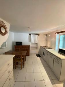 a kitchen with a table and a dining room at Joli studio en plein centre ville - Nyons in Nyons +9 photos