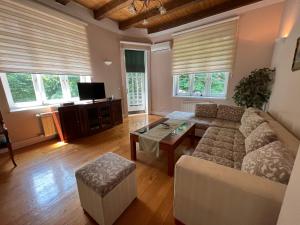 a living room with a couch and a table at Villa Donata in Sarajevo