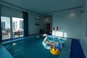 a person in a swimming pool with a pool float at The One chalet Oman in Bū ‘Abālī