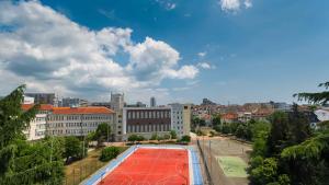 a view of a city with a red tennis court at Central DELUXE Apartment in Burgas City