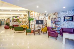 a waiting room with colorful chairs and tables at Arsi Hotel in Alanya