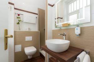 a bathroom with a sink and a toilet at Hotel Fürst Bismarck in Hamburg