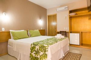 Uma cama ou camas num quarto em Dunas de Itaipu