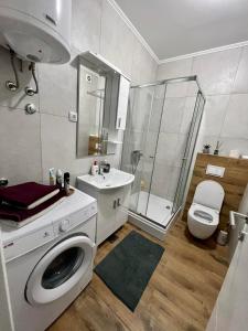a bathroom with a toilet sink and a shower at Apartman IRIS 3 in Banja Luka