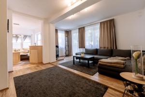 a living room with a couch and a table at Apartment Steindl in Längenfeld