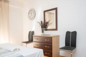 - une chambre avec une commode avec un miroir et 2 chaises dans l'établissement Apartment Paula, à Zadar