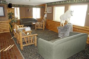 a living room with a horse statue on a rock at Pellston Lodge in Pellston