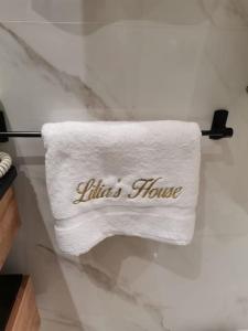 a white towel with the words littles house on it at Lilia's house Al Kantaoui in Sousse