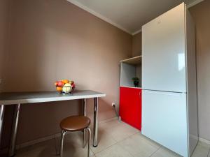 a kitchen with a table and a refrigerator at Apartamenty Romano in Rzeszów +38 photos